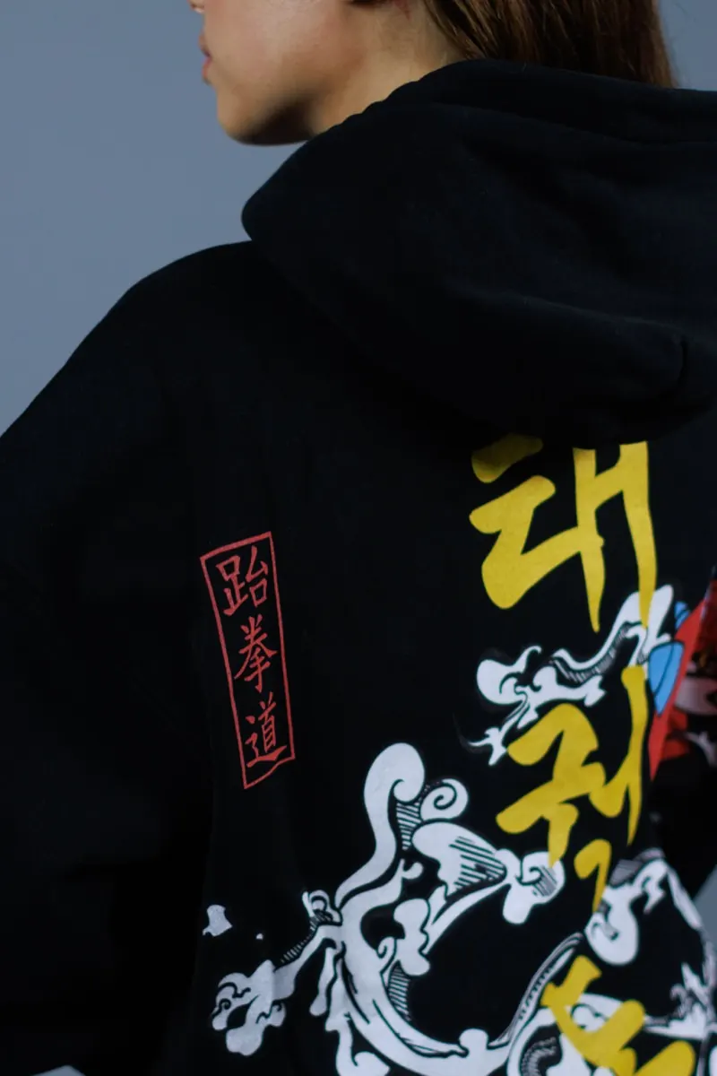 Close-up of a multi-colour print on a black hoodie
