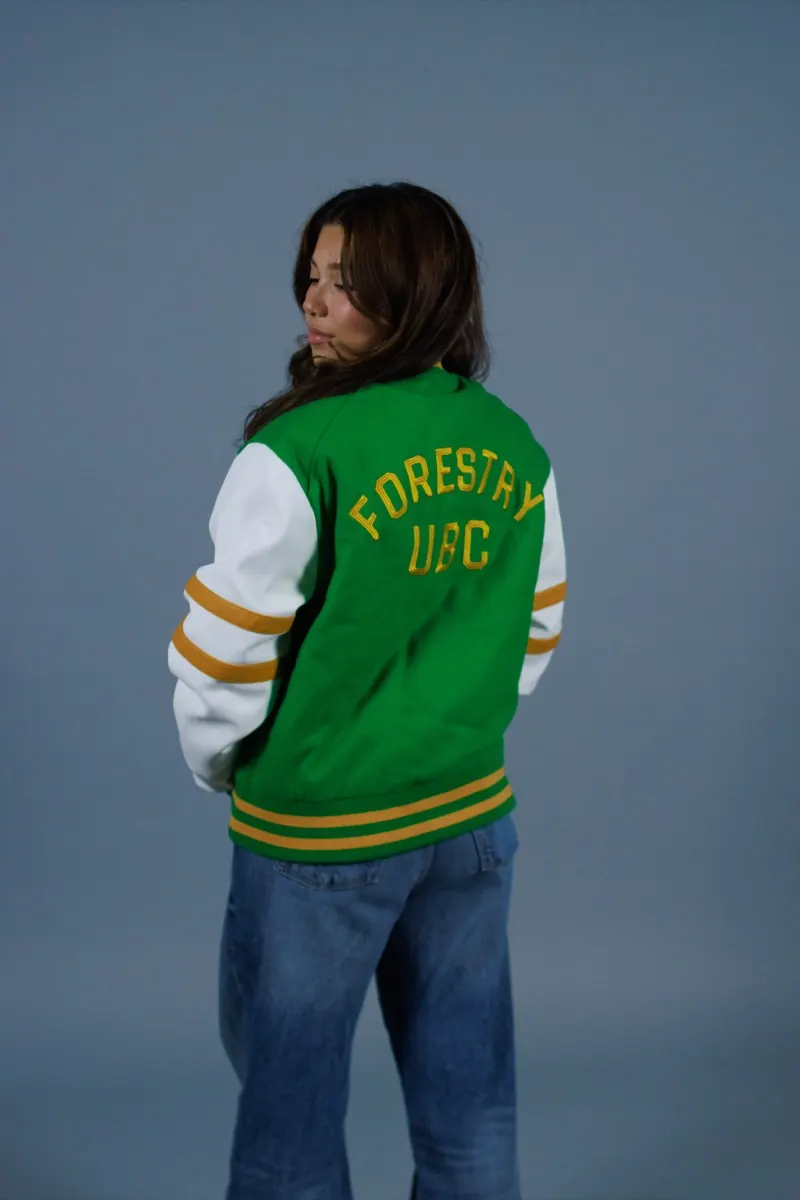 Green varsity jacket with 'Forestry UBC' lettering on the back and gold-striped sleeves